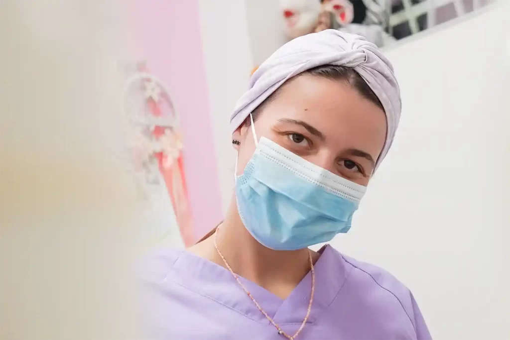 dra maria barroso com máscara e farda dentária